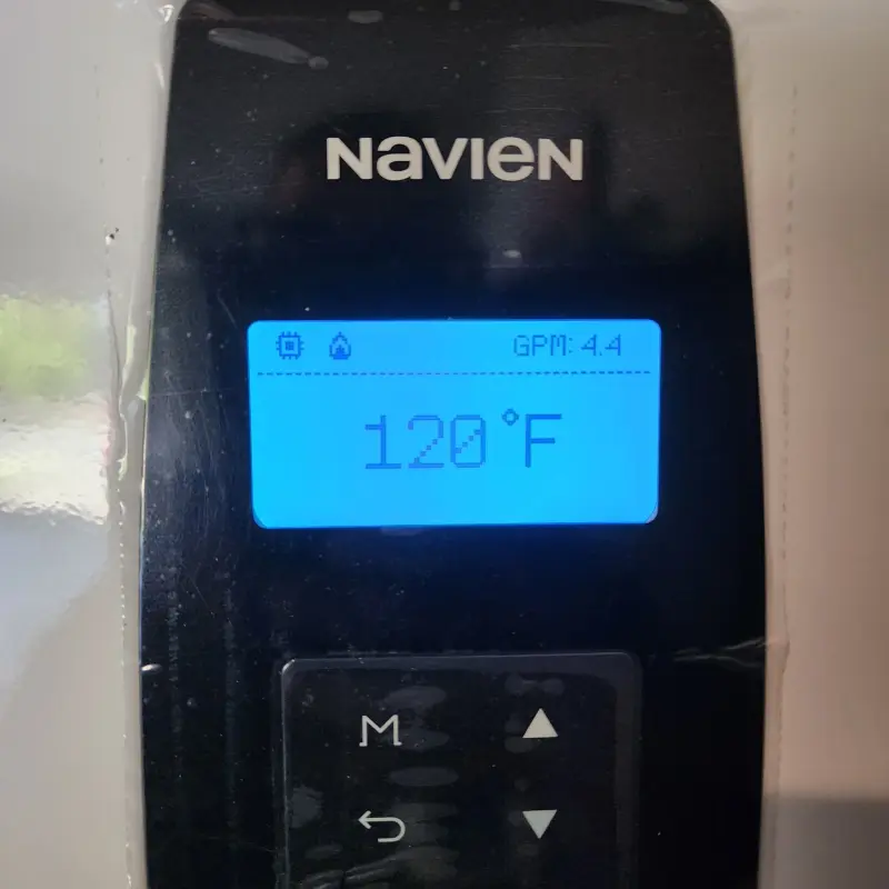 Navien control panel reading 120 degrees Fahrenheit at 4.4 gallons per minute