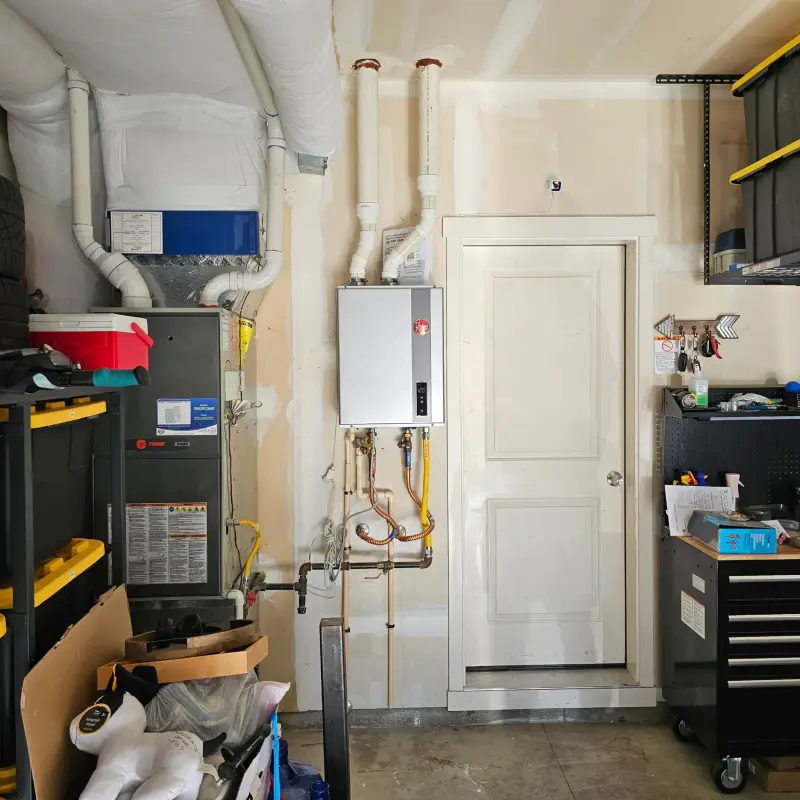 Finished Rheem tankless water heater mounted in the garage with isolation valves and clean venting, display reading 120 degrees