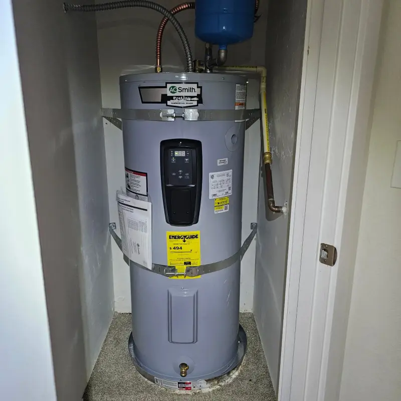 A.O. Smith electric water heater in a closet with seismic straps, expansion tank and drain pan