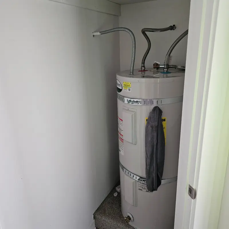 Electric water heater installed in a very narrow closet with seismic straps and flexible connectors
